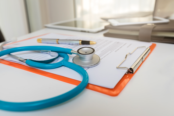 close-up-of-stethoscope-and-paper-clipboard-on-des-2022-10-04-16-48-47-utc