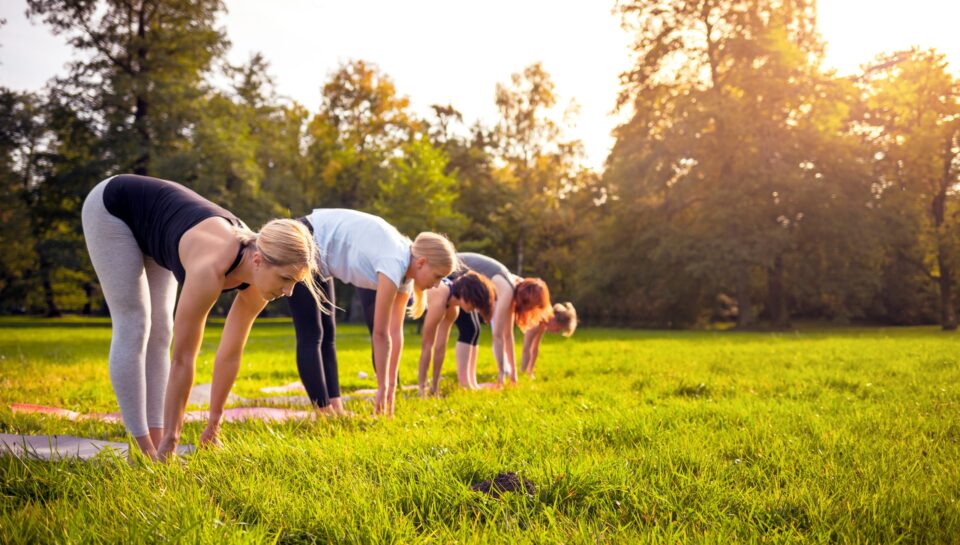 Mixed,Age,Group,Of,People,Practicing,Yoga,Outside,In,The