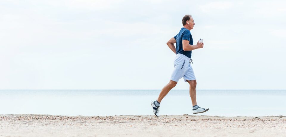 Elderly,Man,Runs,Early,Morning,By,Sea,Beach.,Active,Senior